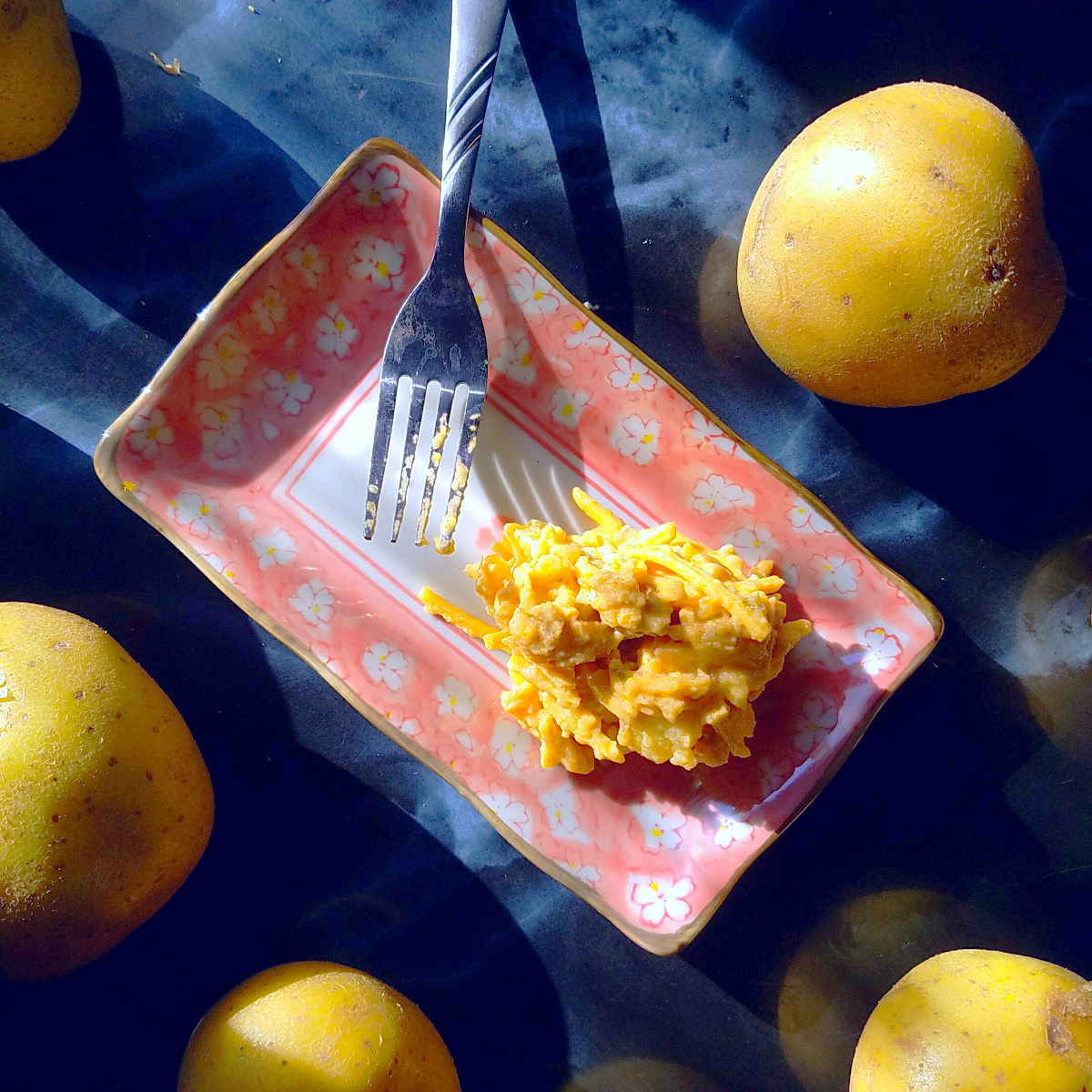 vegan cheddar potato salad on pink plate